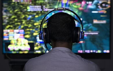 A man wearing headphones while playing video games