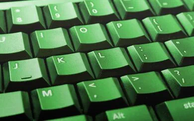 A computer keyboard lit up in green