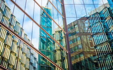 A London skyscraper seen through the reflection of a glass building