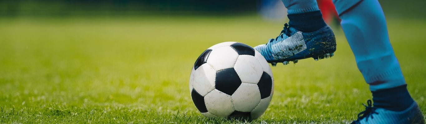 Soccer player kicking soccer ball