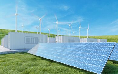 Solar Panels, wind turbines, and a Li-ion battery container showcasing the significance of solar-powered investments and financing in renewable energy.